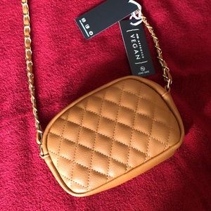 New w/tags La Terre vegan crossbody bag 7”wide 5.5” deep w/inside pockets.
